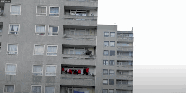 Tall light grey building with balconies