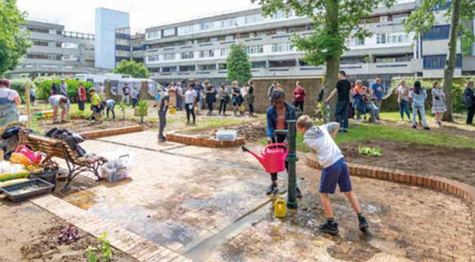 Outdoor space with buildings, trees and people walking