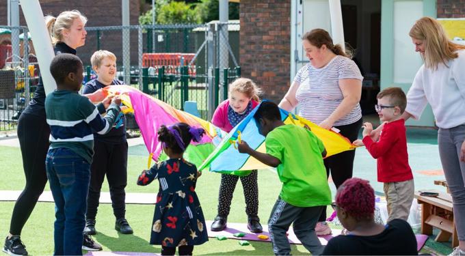 Adults and children playing