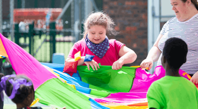 People holding colourful material