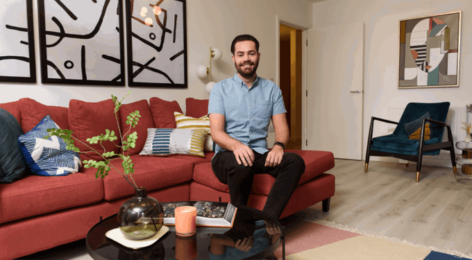 Man sitting on a red sofa