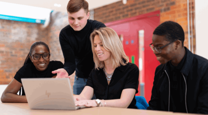 People looking at a laptop